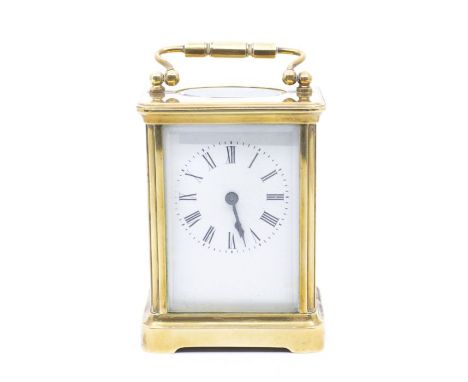A late 19th French brass carriage clock, the white enamel dial with Roman numerals, swing handle in leather travel case, cloc