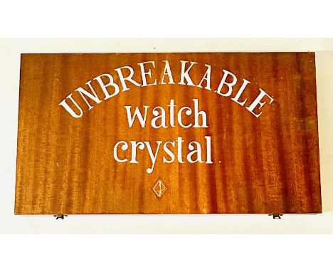 A quantity of watch crystals enclosed in mahogany case along with watchmakers tools.