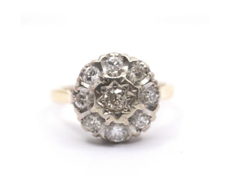 An 18ct diamond cluster ring, the centre stone star set with border of eight further diamonds, 4.2g