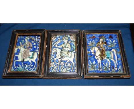 A Persian pottery tile moulded with a falconer in Qajar taste, 17.5cm x 10.5cm. and two similar tiles, all framedcondition: e