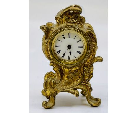 A&nbsp;Rococo design gilt metal alarm clock by the British United clock co, Birmingham, engraved on the back, wind up back. 1