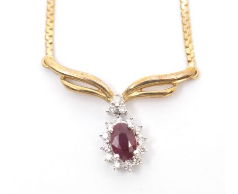 A 9k pendant, claw set oval and ruby surrounded by diamond border with yellow gold bow surmount, suspended on fine link chain