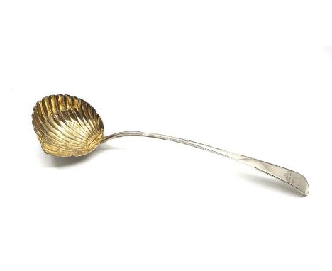 A George III ladle, the shell bowl with gilt interior by George Smith III, London 1782, weight 155g.
