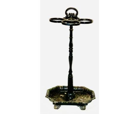 Manner of Coalbrookdale cast iron stick stand, loop handle on a turned column holding four oval stick-holders, on a octagonal