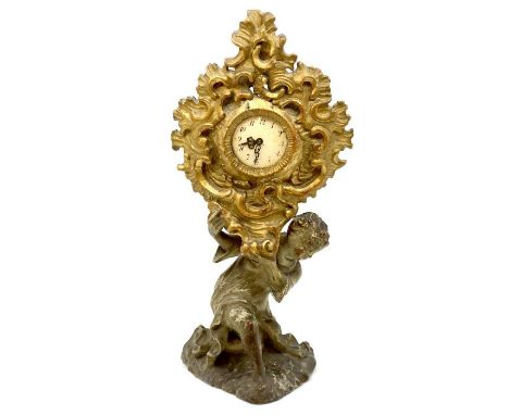 An early 18th century Italian carved and painted wood monstrance, the base as a seated figure. later clock movement, 34cm H