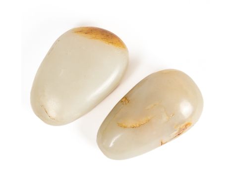 TWO CHINESE JADE PEBBLE-FORM SNUFF BOTTLES (2)Qing dynasty Each of greyish celadon tone with russet and cream inclusions, eac