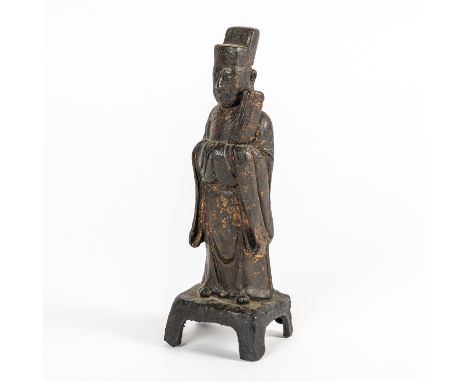 A CHINESE BRONZE FIGURE OF AN OFFICIALMing dynasty, 16th/17th century Cast standing in long robes with a tablet under his fol