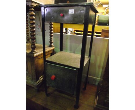 A vintage steel side table of square cut form, partially enclosed by a cupboard beneath a stripped bare metal top
