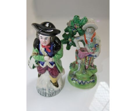 An unusual 19th century pottery figure in the Staffordshire manner but possibly Scottish, showing a man in a green coat carry
