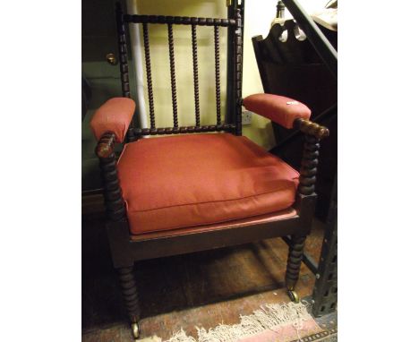 A Victorian bobbin moulded armchair with upholstered seat and arm panels