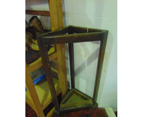 A stained timber stick stand of triangular form