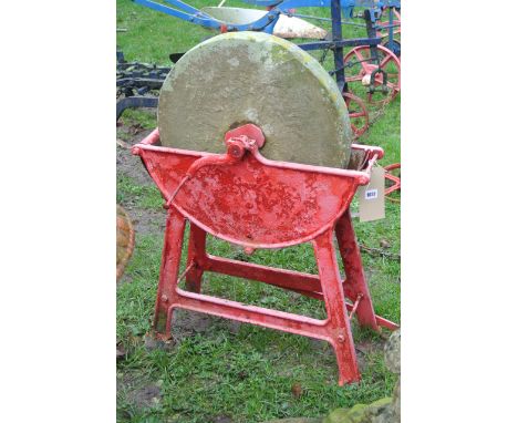 A vintage Sharpening stone, raised/cradled in a cast iron frame (foot pedal operated)