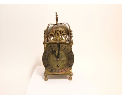 An Old English style lantern clock of unusual form with a Smith's movement providing an eight day time piece