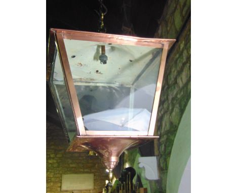 A large antique copper porch/ceiling lantern of tapering rectangular form with four clear glazed panelled sides