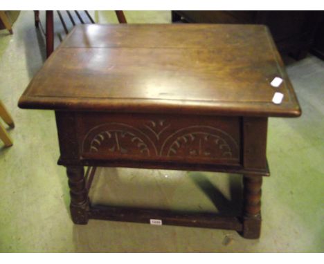 A good quality old English style oak box stool with hinged lid and tapered framework with carved detail and bobbin supports u