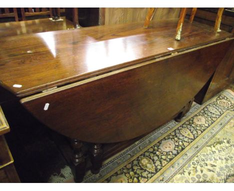 A good large old English style gate leg dining table in oak with double gate action and turned supports, 170 cm max x 55 cm w