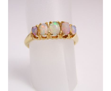 An Edwardian opal ring, set with five graduated oval opals, in 18ct gold, size N 1/2