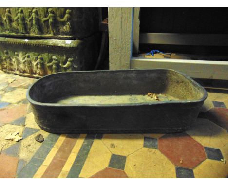 A lead planter of shallow rectangular form, with curved ends and floral relief detail, 74cm long x 32cm wide x 15cm deep appr