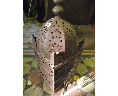 An Eastern hanging candle lantern of square cut and domed form with pierced panels