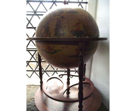 A contemporary drinks trolley in the form of a globe with hinged lid and open turned framework