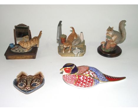 A boxed Royal Crown Derby paperweight in the form of a pheasant with Imari type decoration and gilt coloured stopper to base,
