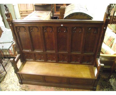 A good quality 19th century ecclesiastical box settle, the raised back with Gothic tracery detail flanked to either end by mu
