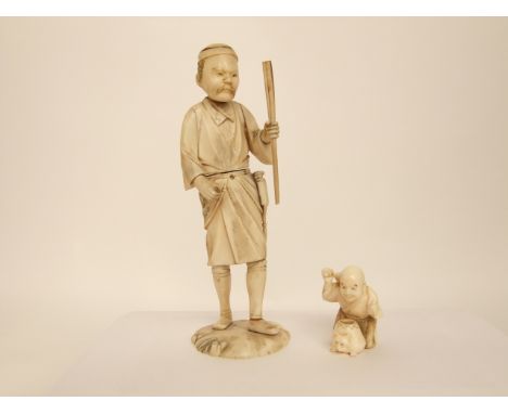 Two late 19th/early 20th century Japanese ivory figures, male traveller with staff, 15 cm, together with a small netsuke crou