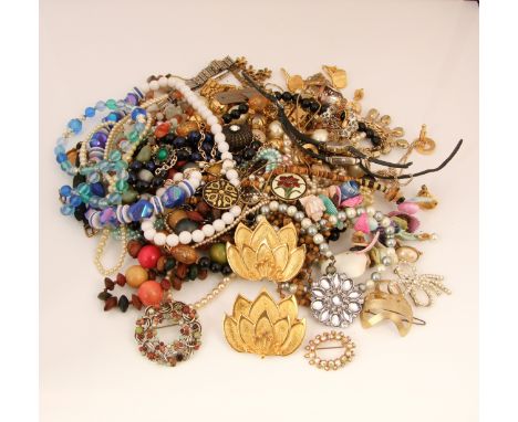 A miscellaneous collection of costume jewellery, including faux pearl necklaces, wristwatches, etc