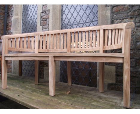 A contemporary hardwood 'banana' shaped garden bench