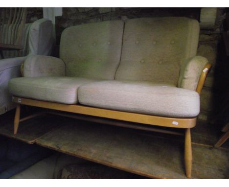 An Ercol two seat sofa with light beechwood frame and simple stick back with loose oatmeal coloured buttoned cushions 