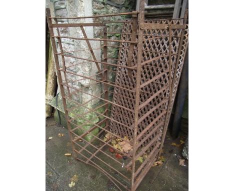 A vintage floorstanding steel fruit rack/stand together with a reclaimed cast iron pierced lattice and ring bordered grill, c