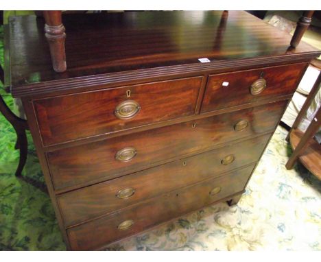 A Georgian mahogany bedroom chest of three long and two short graduated drawers with crossbanded detail and raised on bracket