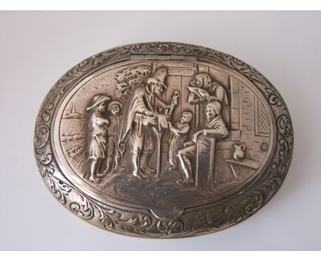 A Dutch silver tobacco snuff box, 830 standard, of oval form, the hinged cover chased with a decorative scene, with scrolling