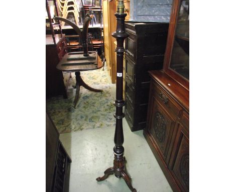 A mahogany standard lamp with turned column and scrolled tripod