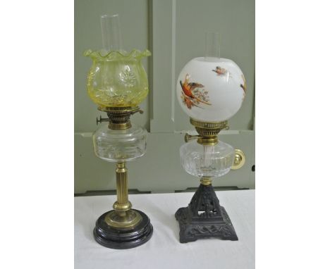 A Victorian oil lamp with partially reeded brass stem, glass reservoir with star cut and further detail, British made Duplex 