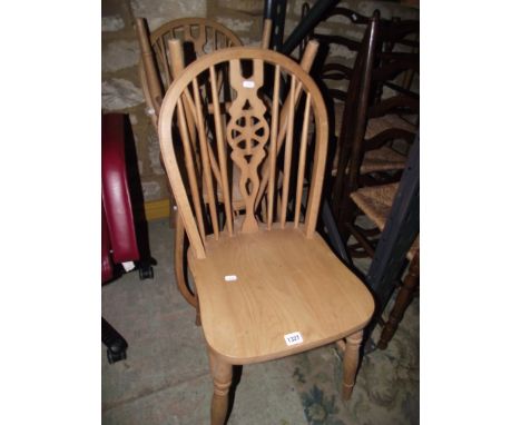 Three contemporary Windsor beechwood hoop and stick back kitchen chairs with central pierced wheel splats