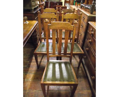 A set of six (5+1) oak dining chairs with stick backs and upholstered seats on square tapered forelegs