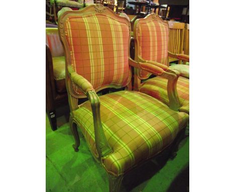 A pair of fauteuils with alternating shades of pink and cream check and striped patterned upholstered seat and back pad withi