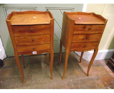 A pair of 19th century fruitwood bedside or lamp tables each fitted with three frieze drawers, raised on shaped supports