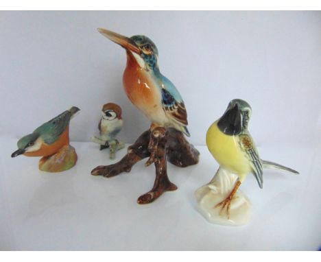A Royal Worcester model of a nuthatch with printed mark to base 3334 together with three continental figures of birds compris