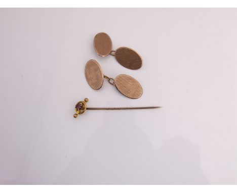 A pair of 9ct rose gold cufflinks, each with engine-turned swastika decoration; and a 9ct gold stick pin, the terminal inset 