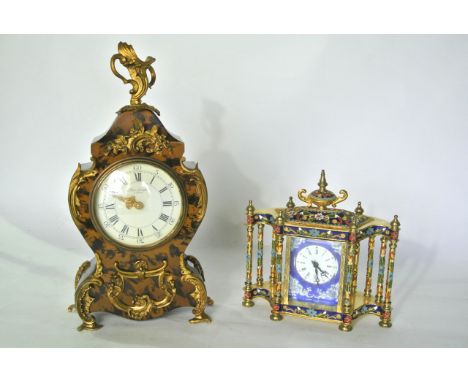 A reproduction French style bracket clock, the waisted case with painted detail and overlaid mounts together with a reproduct