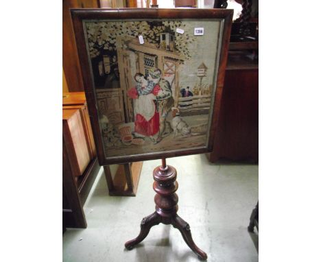 A Victorian pole screen with rise and fall rectangular glazed tapestry panel, partial turned column and scrolled tripod