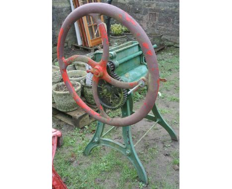 A vintage cast iron agricultural mangle, stamped "Kell Meats & Co. Gloucester No: 4B", together with a hay knife