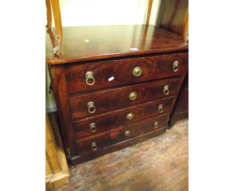 A 19th century mahogany French commode of four long oak lined drawers, flanked by canted corners