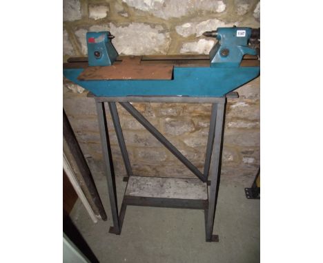 A small lathe/level drill bed on a bench high stand