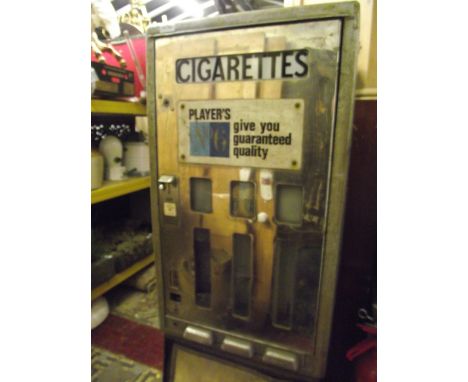 A vintage coin operated cigarette dispenser raised on a tubular steel stand advertising Players Number 6 Give You Guaranteed 