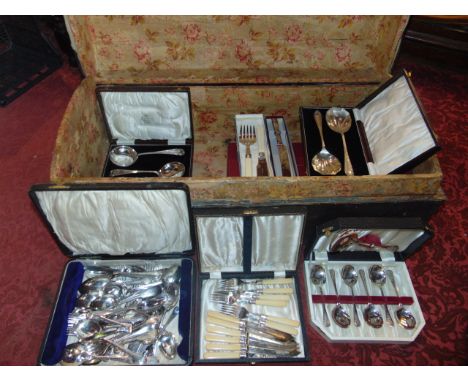 A 19th century banded pine travelling trunk containing approximately 10 boxes of cased silver plated and other cutlery to inc