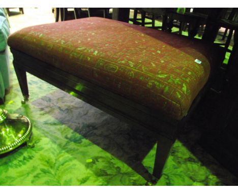 A reproduction mahogany low centre stool of rectangular form in the Georgian style with hieroglyphic type patterned upholster
