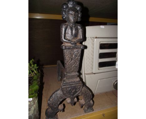 A pair of heavy cast iron andirons with waist length figural portrait finials, tapered column stems and dated 1625, raised on